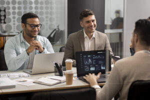 Salesforce Partners discussing salesforce implementation strategies with reports open on laptop
